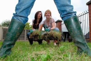 girls installing grass